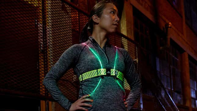 Women wearing Noxgear light vest on her run outside at night. 