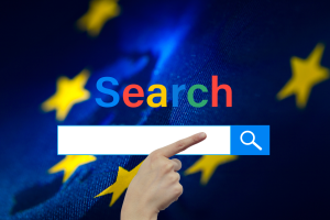 Google introduces new search update to comply with EU tech rules. A hand pointing to a stylized search bar with the word "Search" in colorful letters against a dark blue background with bokeh effect featuring out-of-focus stars resembling the European Union flag.