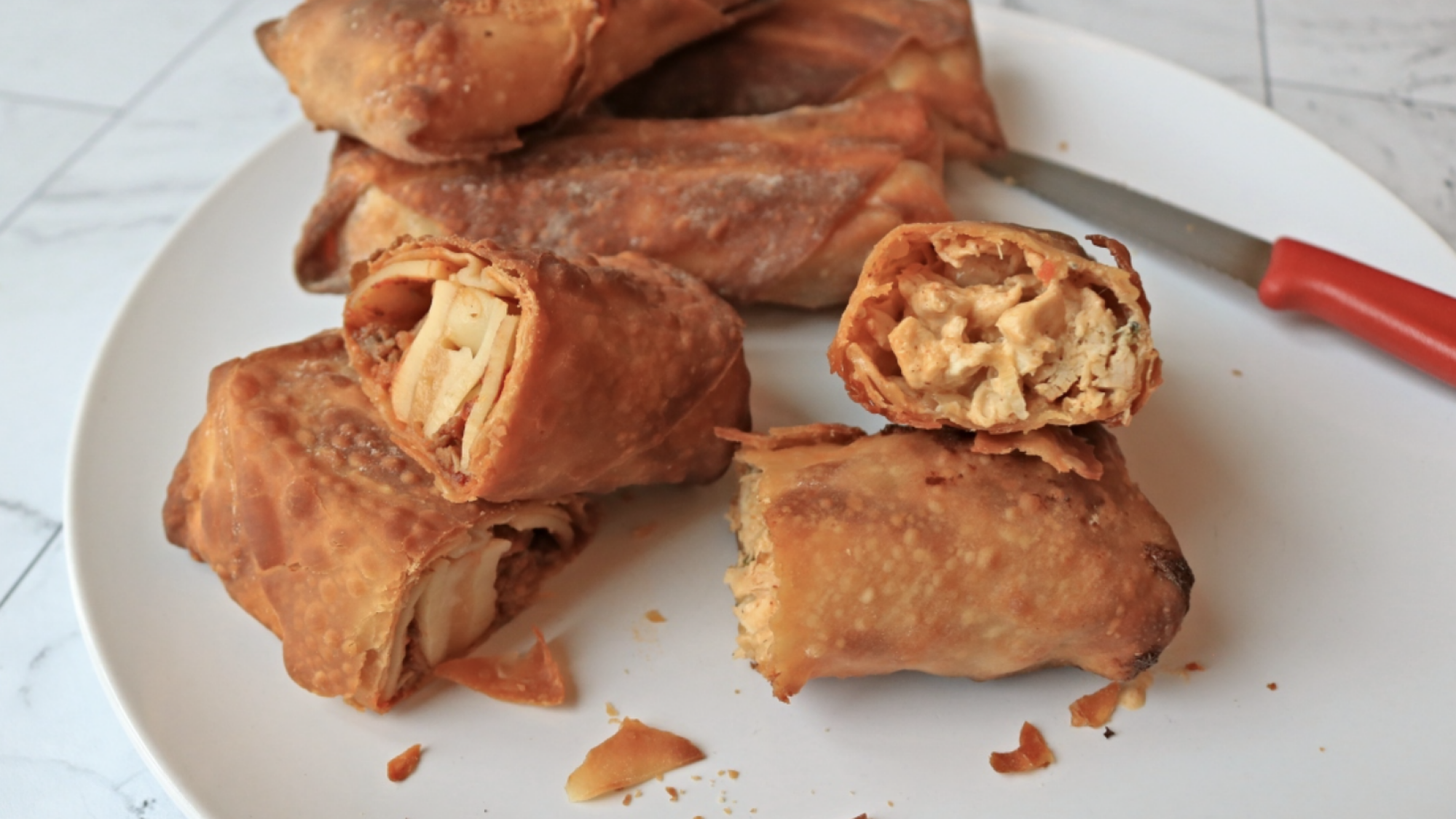 Egg rolls on a plate.