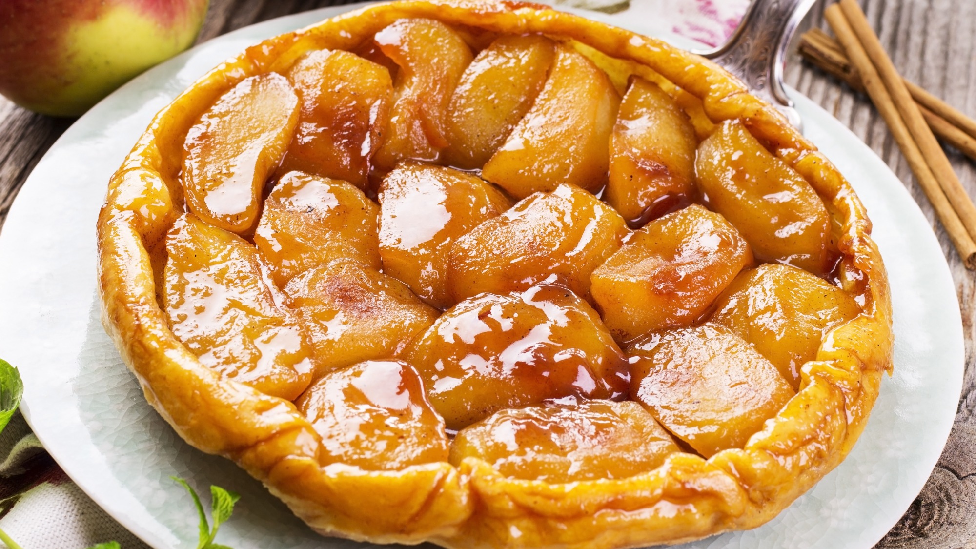 An apple tarte tatin on a white plate.